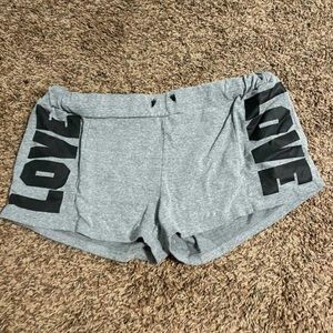 Grey shorts with “LOVE” written on each side in black